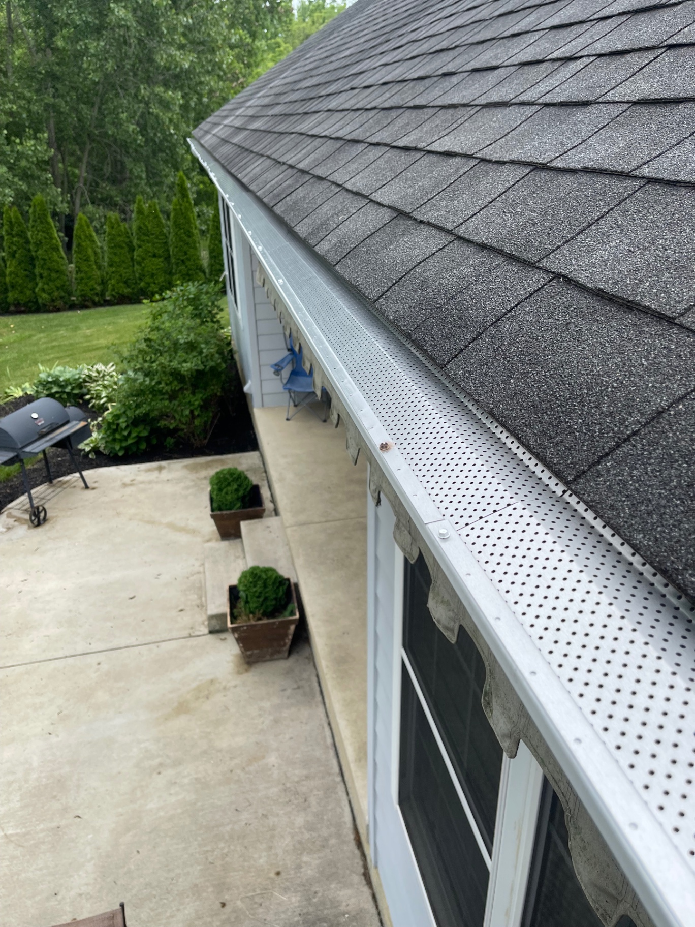 Freshly installed perforated aluminum gutter guards on a residential home