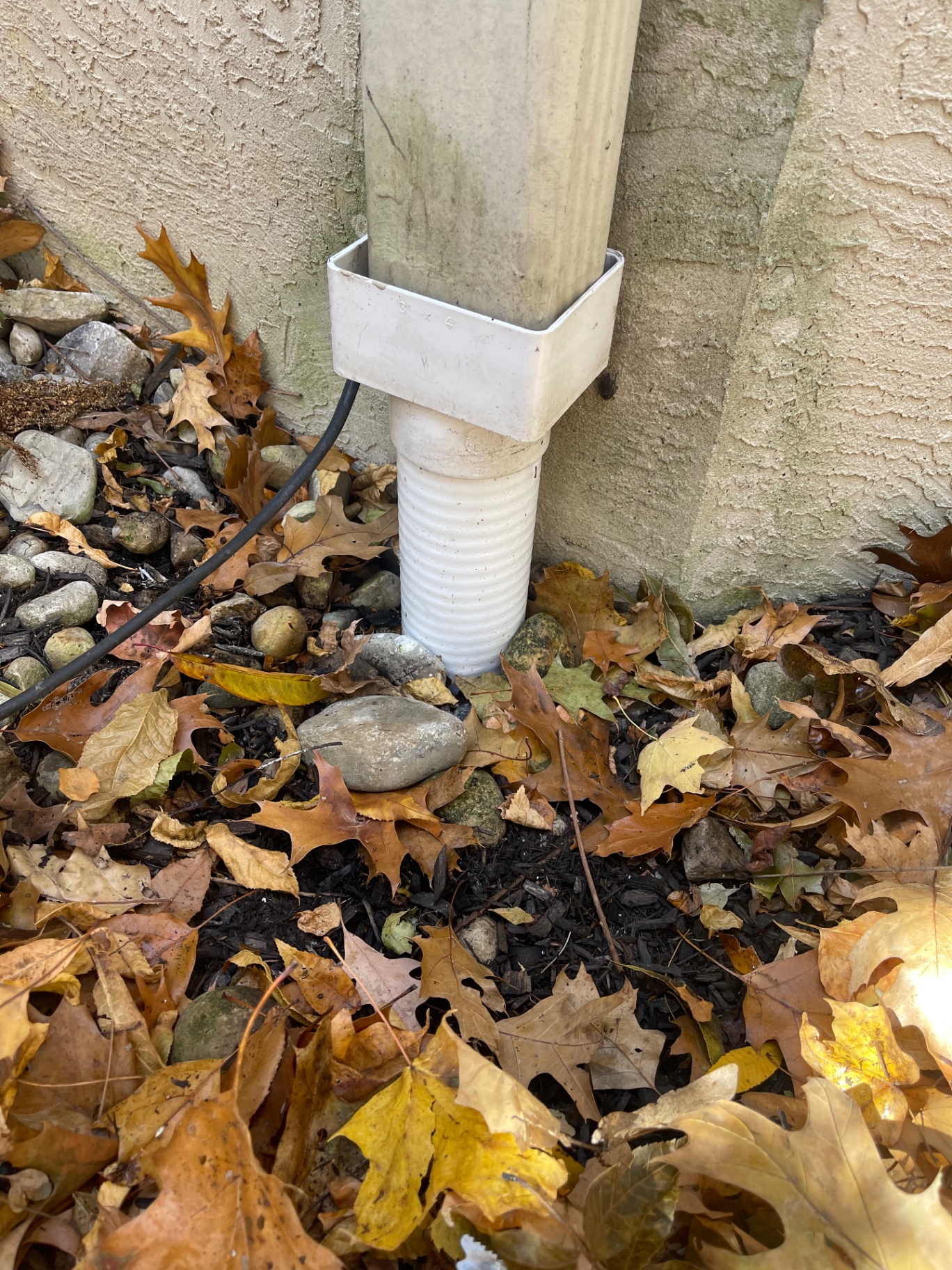 Downspout connected securely into corrected ground drain adapter