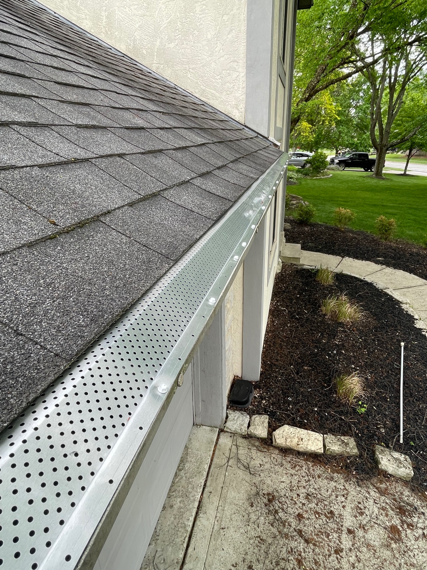 Gutter guards installed along a stucco home in Central Ohio