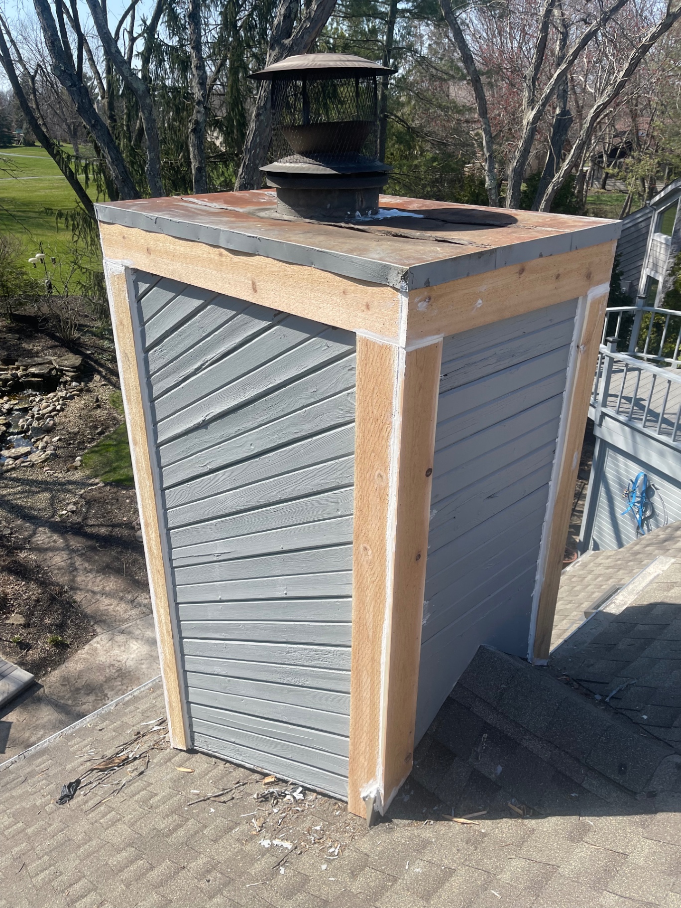 Chimney chase being rebuilt with fresh wood trim