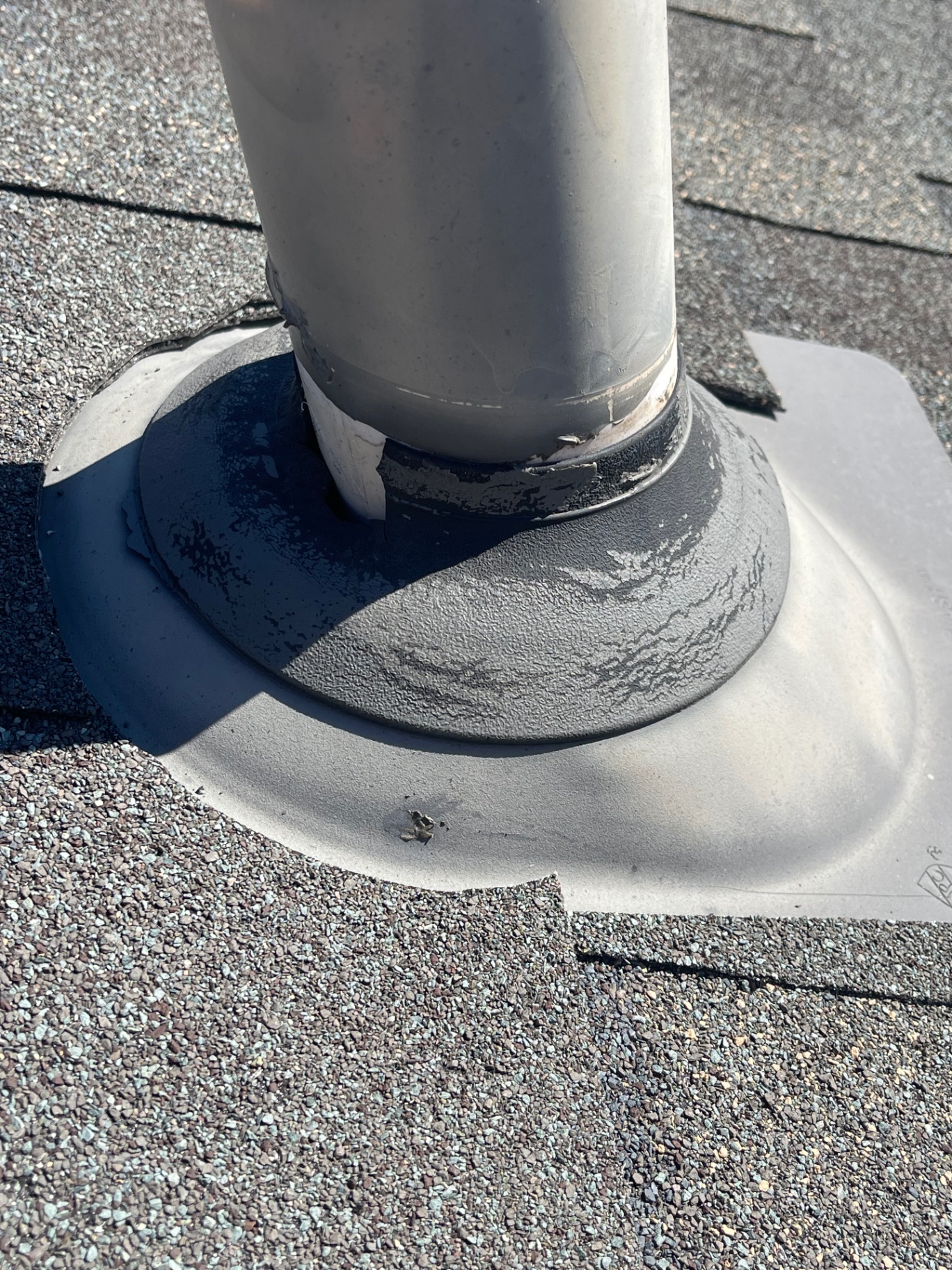 Roof pipe boot flashing before repair with visible wear and sealant